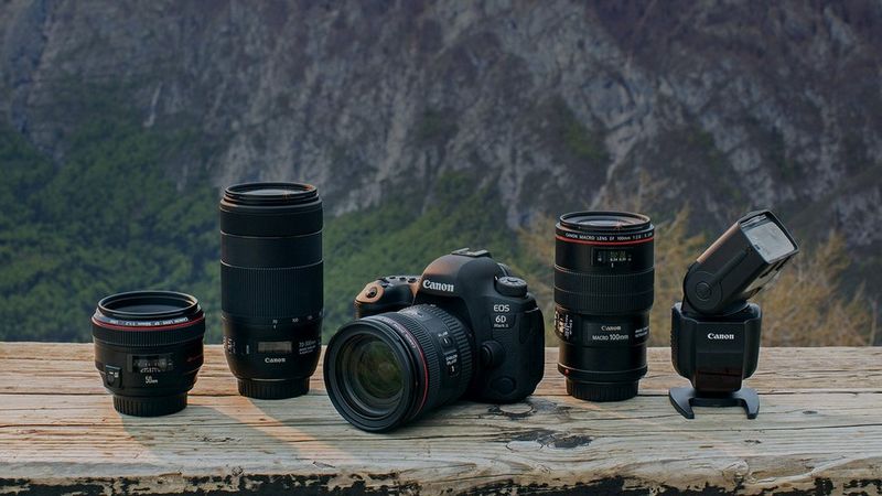 Canon range of EOS camera and lenses with a mountain background